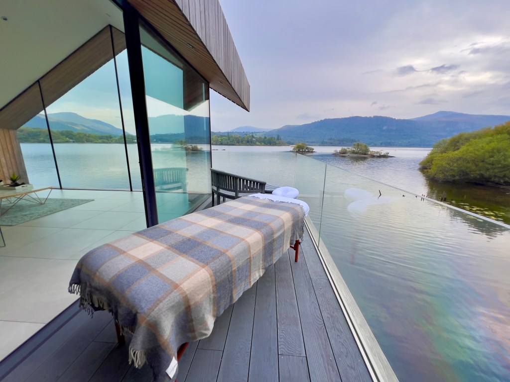 The Boat House at The Lingholm Estate overlooking the lake with massage table on the terrace.